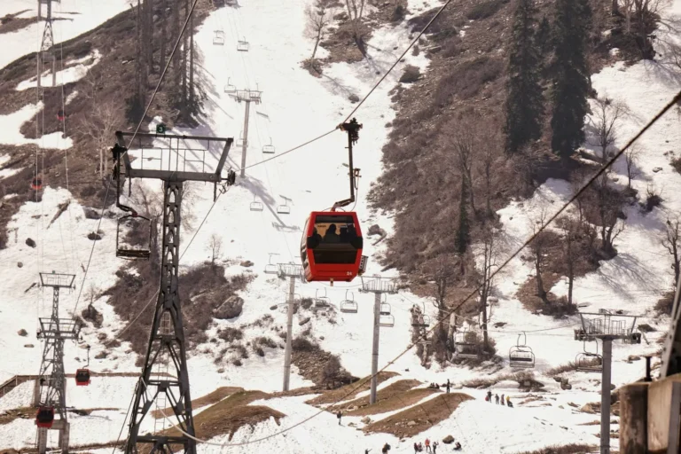 Gulmarg Gondola cabin and chairlift over the snowy slopes