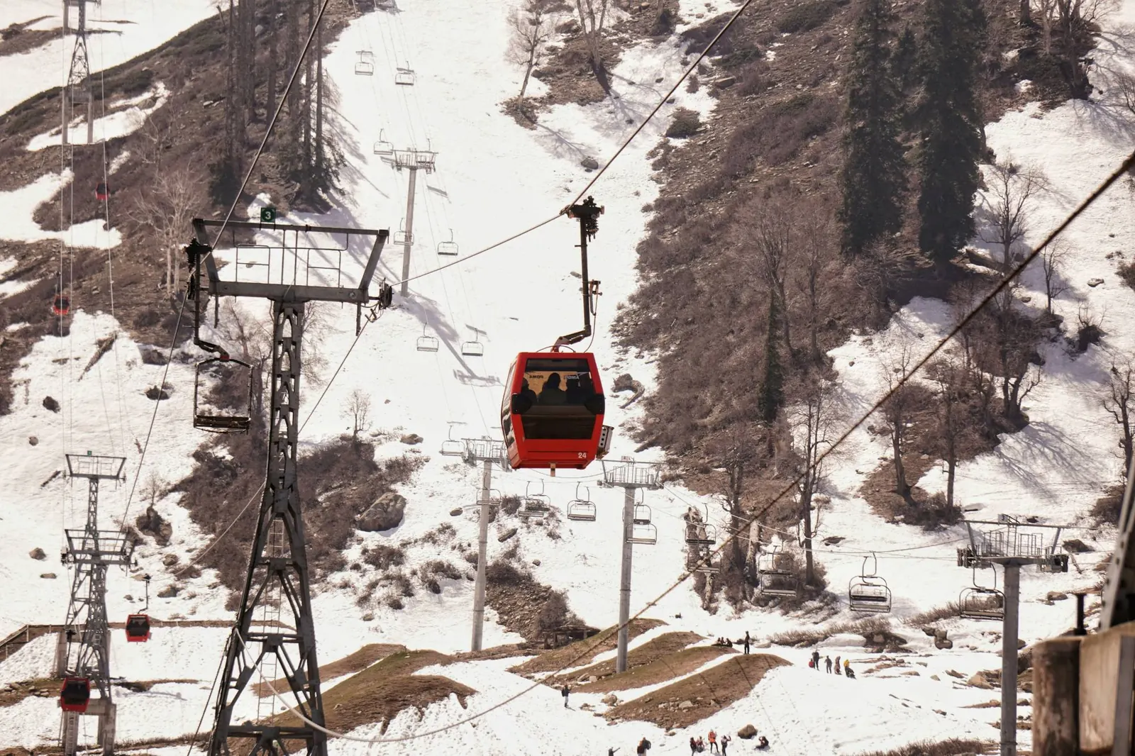 Gulmarg Gondola cabin and chairlift over the snowy slopes